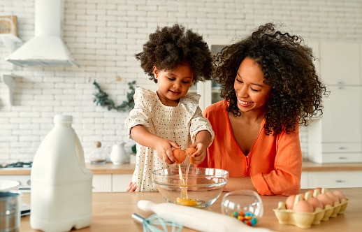 Child baking with her mom