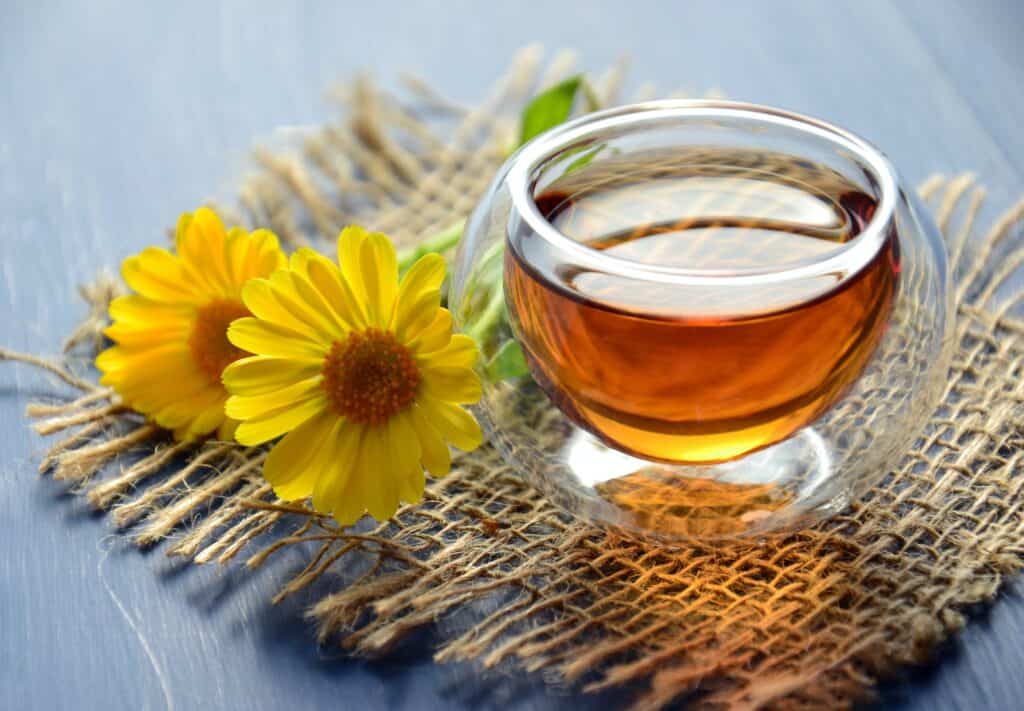 honey in a bowl with flower.  Natural sweetner