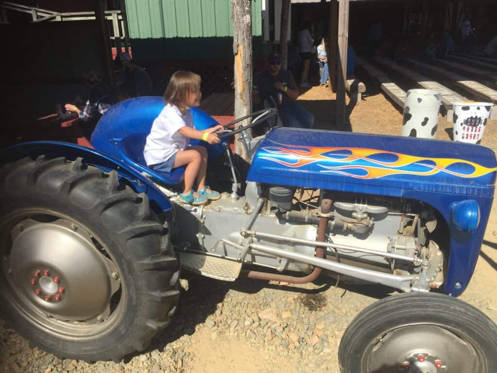 girl on a classic tractor