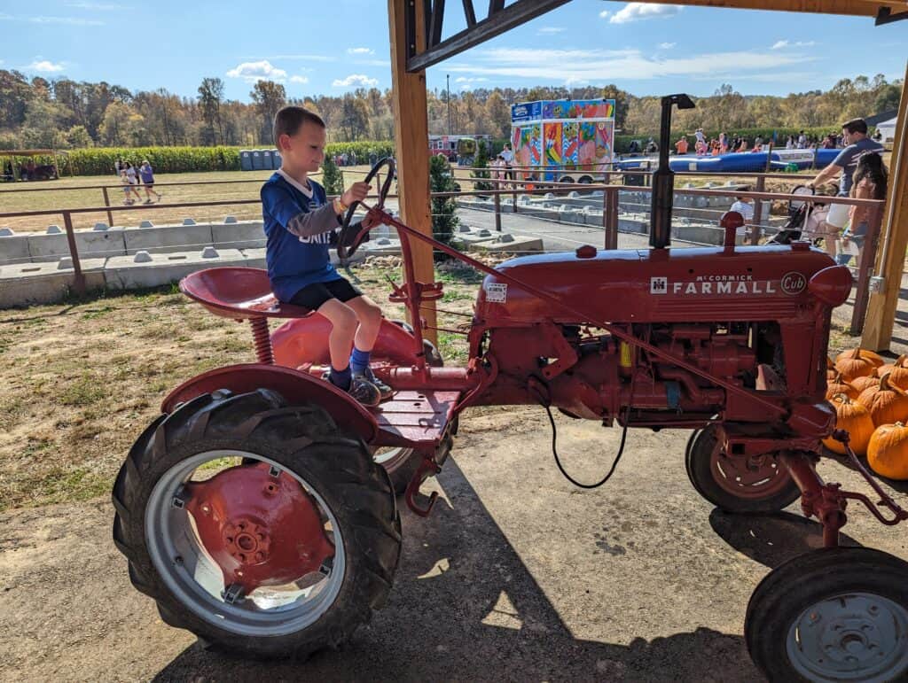 boy on a classic farmall tractor